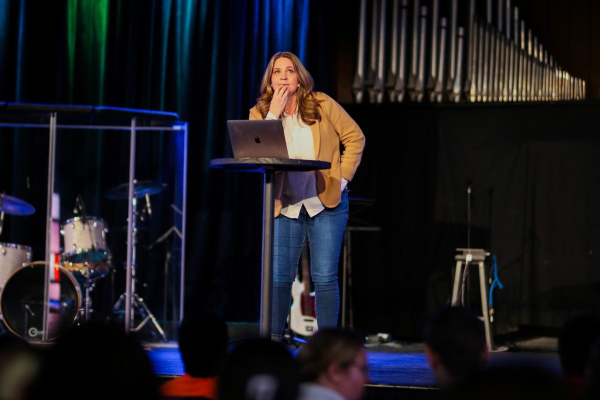 Jen on stage speaking to a full room